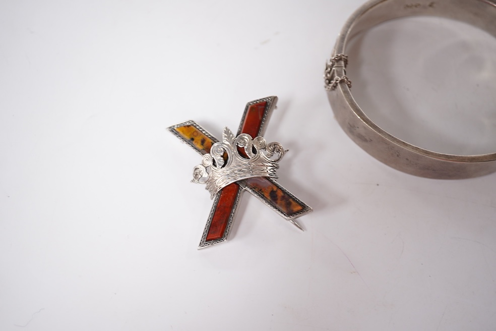 A late Victorian white metal and Scottish hardstone set 'X' brooch with coronet, 34mm, together with a silver hinged bangle and a George V silver mounted handbag mirror, with Reynold's Angels decoration. Condition - poor